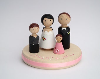 Cake topper with two children and pennants