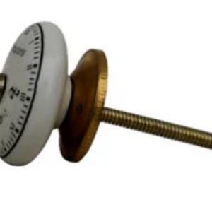 May include: White ceramic knob with black markings and a gold metal screw. The knob has a circular design with numbers and markings around the edge.