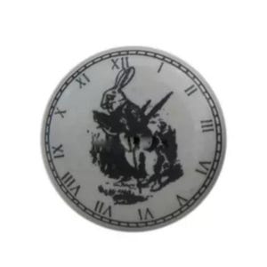 May include: A white ceramic clock face with black Roman numerals and a black and white image of the White Rabbit from Alice in Wonderland.