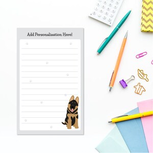 May include: A gray notepad with lined paper and a black and brown German Shepherd dog illustration. The notepad has the text "Add Personalization Here!" at the top.