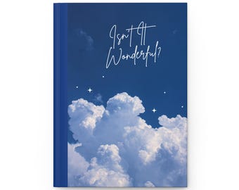 May include: A blue notebook with a white cloud and star design. The text "Isn't it Wonderful?" is written in white on the cover.