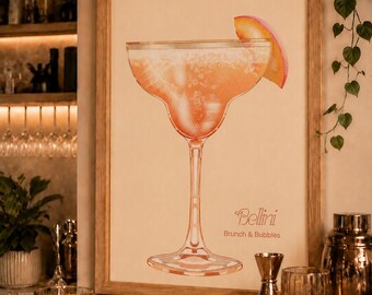 May include: A framed vertical wall art print featuring a watercolor illustration of a peach-colored Bellini cocktail in a stemmed glass with a peach slice garnish. The text "Bellini" and "Brunch & Bubbles" is printed in a brown script and sans-serif font.