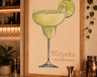 May include: A framed vertical wall art print featuring a watercolor illustration of a lime-garnished margarita in a stemmed glass. The text reads "Margaritas" in a script font above the printed text "LIFE IS BETTER WITH" in a sans-serif font.