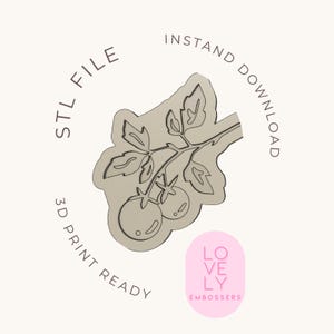 May include: A beige STL file design of a tomato plant branch with three tomatoes and leaves. The words "STL FILE", "INSTANT DOWNLOAD", and "3D PRINT READY" are printed around the design. A pink oval logo with the words "LOVELY EMBOSSERS" is in the bottom right corner.