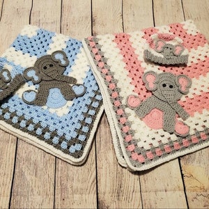 May include: Two crocheted baby blankets with elephant appliques. One blanket is blue and white with a gray elephant, the other is pink and white with a gray elephant.