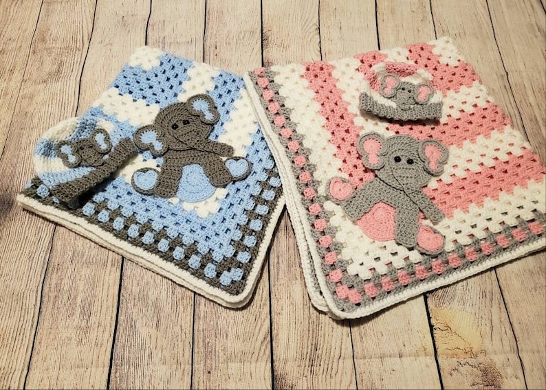 May include: Two crocheted baby blankets with elephant appliques. One blanket is blue and white with a gray elephant, the other is pink and white with a gray elephant.