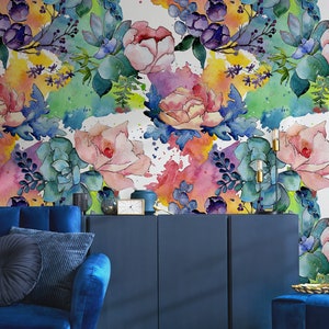 May include: A watercolor floral wallpaper with pink, blue, and green flowers and leaves on a white background. The wallpaper has a painterly, abstract look.