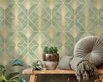 May include: Sage green wallpaper with a gold geometric art deco pattern. A wooden shelf displays a potted cactus, a small succulent, a woven basket, and a gray round pillow. A green blanket and a round pillow are also on the shelf.