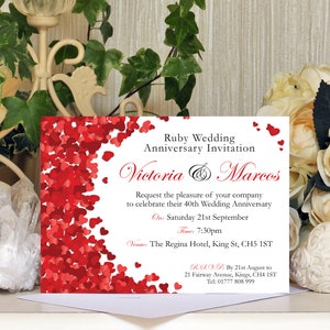 May include: A white invitation card with red hearts scattered across the background. The text reads "Ruby Wedding Anniversary Invitation Victoria & Marcos Request the pleasure of your company to celebrate their 40th Wedding Anniversary On: Saturday 21st September Time: 7:30pm Venue: The Regina Hotel, King St, CH5 1ST R.S.V.P. By 21st August to 21 Fairway Avenue, Kings, CH4 1ST Tel: 01777 808 999"