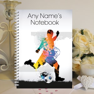 May include: A spiral bound notebook featuring a colourful football player graphic and the text "Any Name's Notebook".
