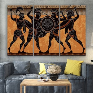 May include: A three-panel canvas print depicting a scene of four ancient Greek warriors in black silhouettes against an orange background. The warriors are holding spears and shields, and the background features a repeating geometric pattern.