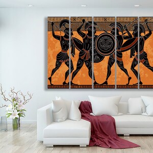 May include: A multi-panel canvas print featuring four ancient Greek warriors in black silhouettes against an orange background. The warriors are holding spears and shields, and their armour is detailed with black lines. The background is a stylised pattern of orange and black.