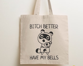 May include: A beige canvas tote bag featuring a black graphic of a raccoon character holding a star-shaped bag. The text BITCH BETTER HAVE MY BELLS is printed in black capital letters above and below the character illustration on the bag.