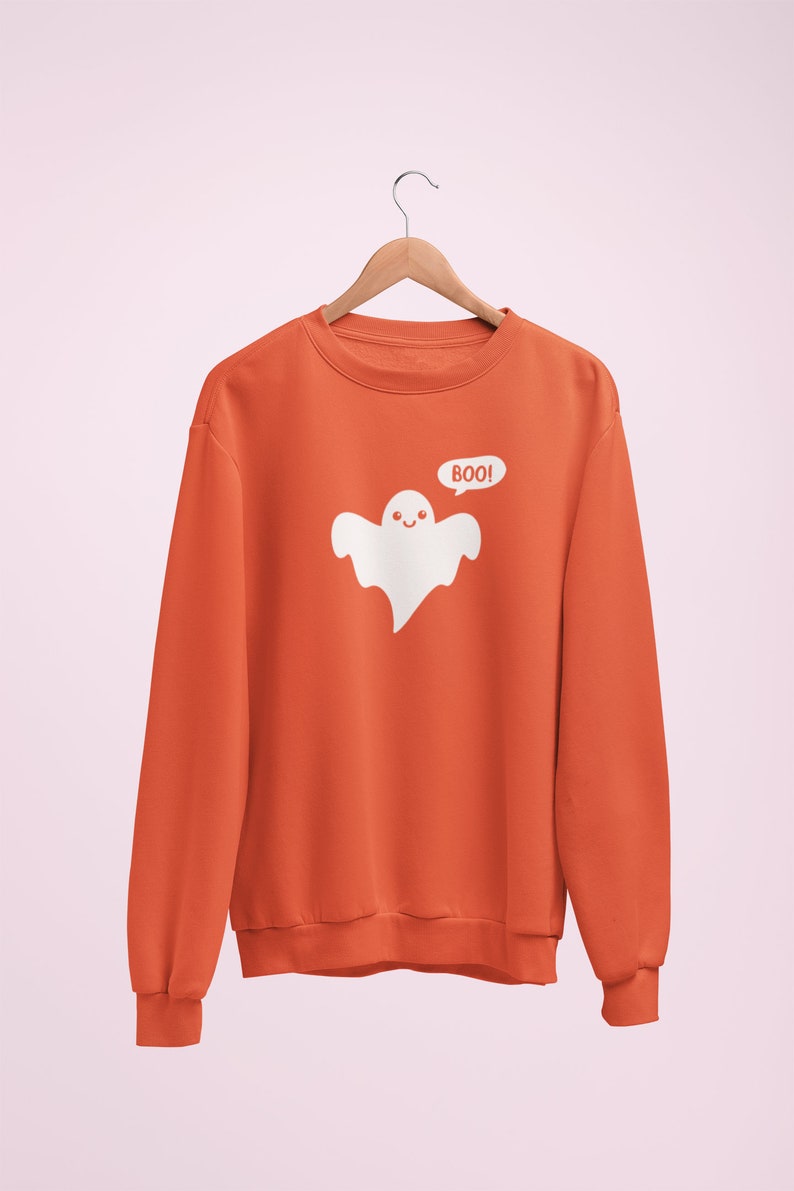 May include: Orange sweatshirt with a white ghost graphic and the text "BOO!" printed on the front.
