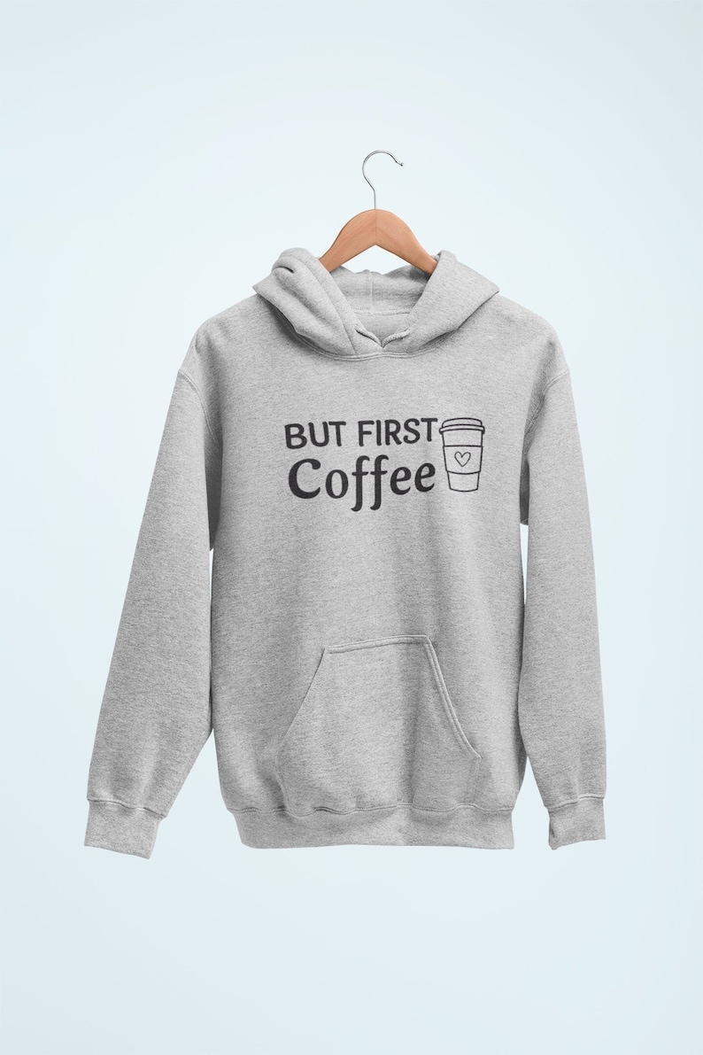May include: Gray hooded sweatshirt with the text "But First Coffee" and a drawing of a coffee cup with a heart on it.