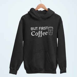 May include: A black hooded sweatshirt with the text "But First Coffee" and a white outline of a coffee cup with a heart on it.