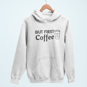 May include: A gray hoodie with a black graphic that says "But First Coffee" and a coffee cup with a heart on it.