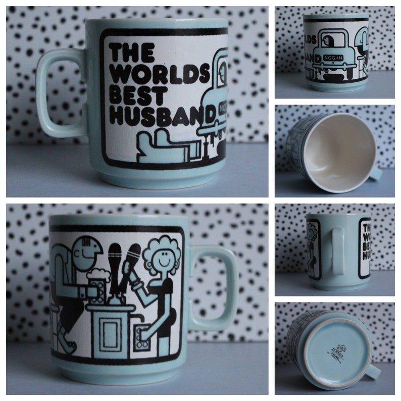 May include: A light blue ceramic mug with black and white illustrations. The mug has a handle and says "The Worlds Best Husband" on the front. The illustration on the front shows a man and a woman at a bar.
