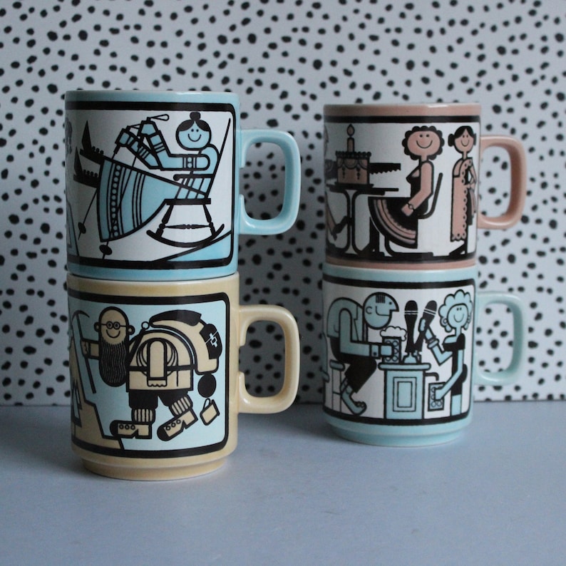 May include: Set of four vintage ceramic mugs with colourful illustrations. Each mug features a different design with people and objects. The mugs are stacked on top of each other.