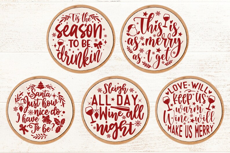 May include: Set of six round wooden signs with red text and images. The signs feature Christmas-themed sayings about wine, such as "Tis the season to be drinkin'" and "Sleigh all day, wine all night".