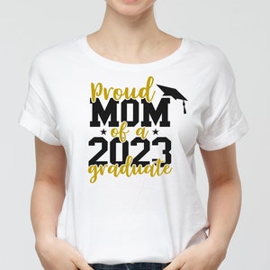 May include: White t-shirt with black text that reads "Proud Mom of a 2023 graduate" with a gold graduation cap graphic.