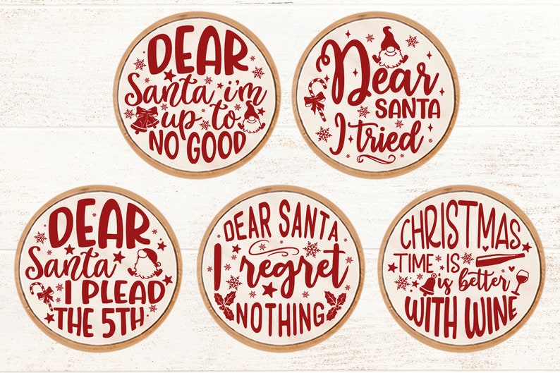 May include: Six round wooden signs with red text and white backgrounds. The signs feature Christmas-themed sayings, including "Dear Santa I'm up to no good", "Dear Santa I tried", "Dear Santa I plead the 5th", "Dear Santa I regret nothing", "Christmas time is better with wine".
