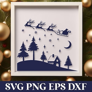 May include: A white frame with a blue silhouette of a Christmas scene. Santa Claus is flying in a sleigh pulled by reindeer over a snowy landscape with a house and pine trees. The frame is surrounded by gold Christmas ornaments.