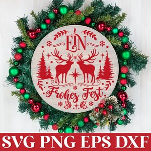 May include: A white wooden round sign with red text and a red deer silhouette design. The sign says "Ein Frohes Fest" and is decorated with snowflakes and holly. The sign is surrounded by a green Christmas wreath with red and green ornaments.