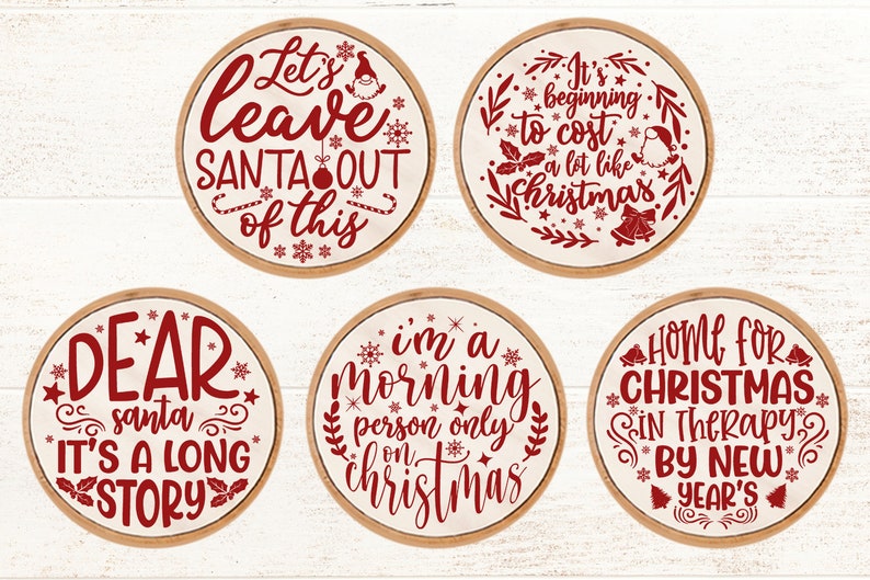 May include: Six round wooden signs with red text and Christmas-themed sayings. The signs read "Let's leave Santa out of this", "It's beginning to cost a lot like Christmas", "Dear Santa it's a long story", "I'm a morning person only on Christmas", "Home for Christmas in therapy by New Year's".