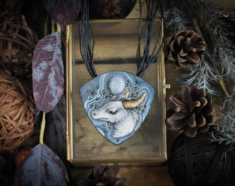 Fantasy necklace with frozen dragon. Unusual fairy jewelry. Cold color jewellry with a fabulous creature.