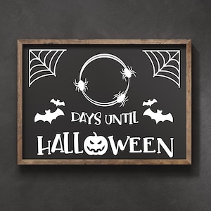 May include: A black chalkboard with a wooden frame displays a Halloween countdown. The chalkboard features white text that reads "Days Until Halloween" with a pumpkin and bats. There are also spiderwebs and spiders on the chalkboard.