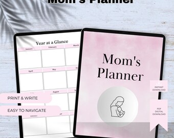 May include: Two digital planners, one open to a year-at-a-glance calendar and the other displaying "Mom's Planner" with a mother and baby illustration. The cover has a pink watercolour background. Text includes "Print & Write" and "Easy to Navigate."