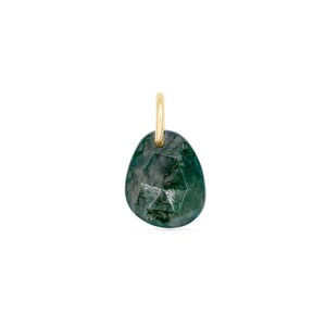 May include: A faceted, teardrop-shaped pendant with a gold-coloured bail. The pendant is a deep green colour with darker inclusions, giving it a marbled appearance. The gemstone is cut with multiple facets.