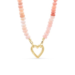 May include: A necklace featuring a strand of small, round, pale pink beads. The two ends of the bead strand are connected to a gold-toned metal heart-shaped clasp that serves as a central pendant, creating a continuous circular jewelry piece.