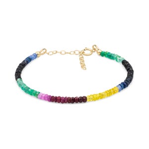 May include: A multi-colored gemstone bracelet featuring small, faceted rondelle beads in shades of green, pink, red, yellow, blue, and black. The bracelet includes a gold-toned metal chain, a circular spring ring clasp, and a short extender chain.