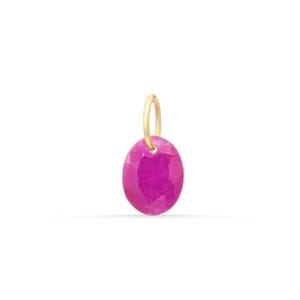 May include: A faceted oval-shaped hot pink gemstone pendant suspended from a small gold-toned metal bail. The stone features a vibrant magenta hue with a polished surface that reflects light, attached to a simple circular gold loop at the top.