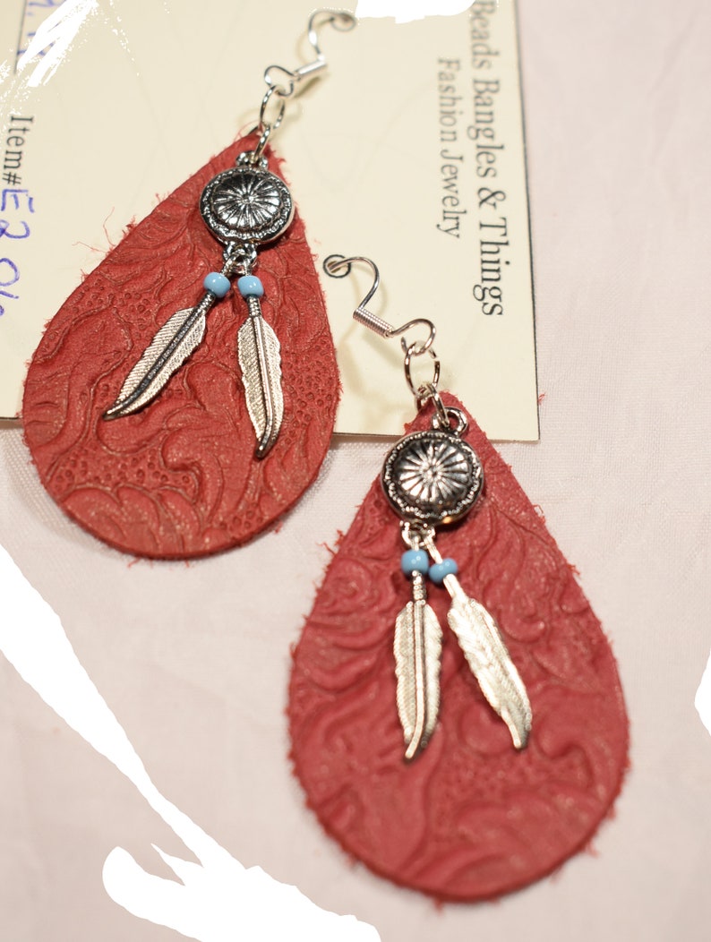 Women\u2019s Red Leather Teardrop earring on sterling silver hooks with silver feather charms