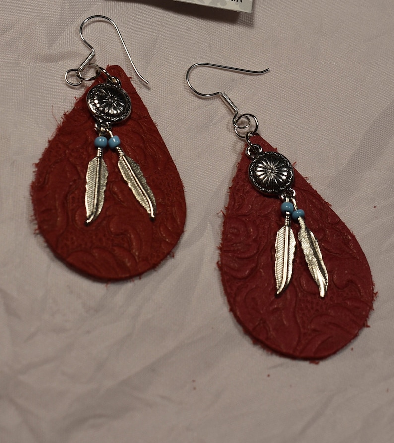 Women\u2019s Red Leather Teardrop earring on sterling silver hooks with silver feather charms