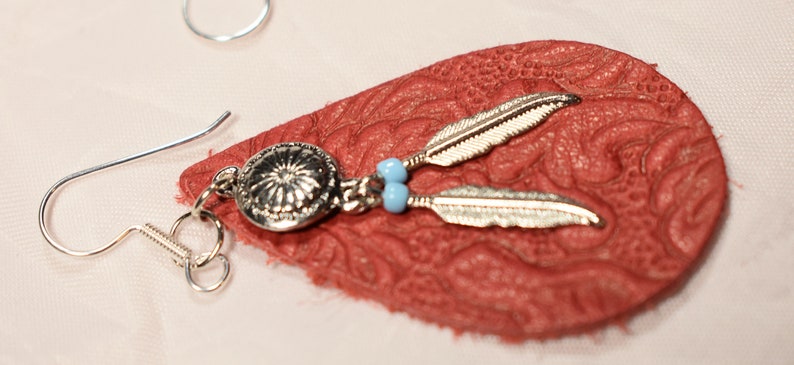 Women\u2019s Red Leather Teardrop earring on sterling silver hooks with silver feather charms
