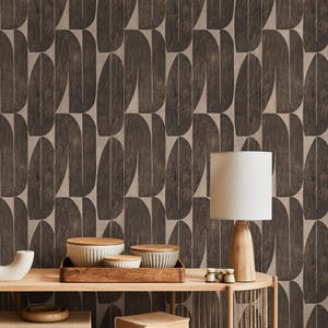May include: A mid-century modern interior scene featuring a wooden console table with a lamp, bowls, and decorative items. The backdrop is a wallpaper with a repeating pattern of dark brown, elongated shapes against a light brown background.