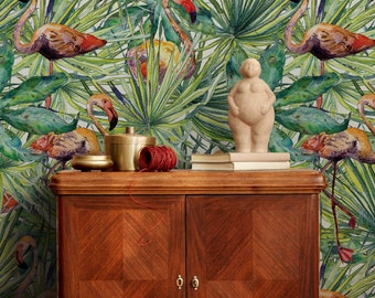 May include: A wooden cabinet with two doors and a light brown finish. The cabinet is decorated with a tropical wallpaper featuring pink flamingos and green palm leaves.