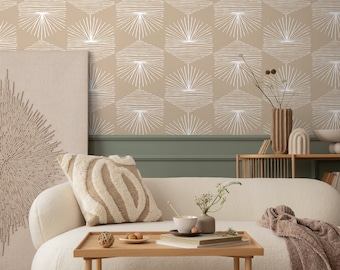 May include: A living room with a beige couch and a coffee table. The wall is covered in beige wallpaper with a white geometric pattern of sunbursts. There is a vase with dried flowers on a wooden shelf.