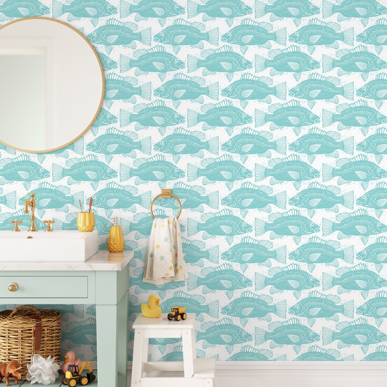 May include: Teal blue fish pattern wallpaper with a white background. The wallpaper is shown in a bathroom setting with a sink, mirror, and a small stool.