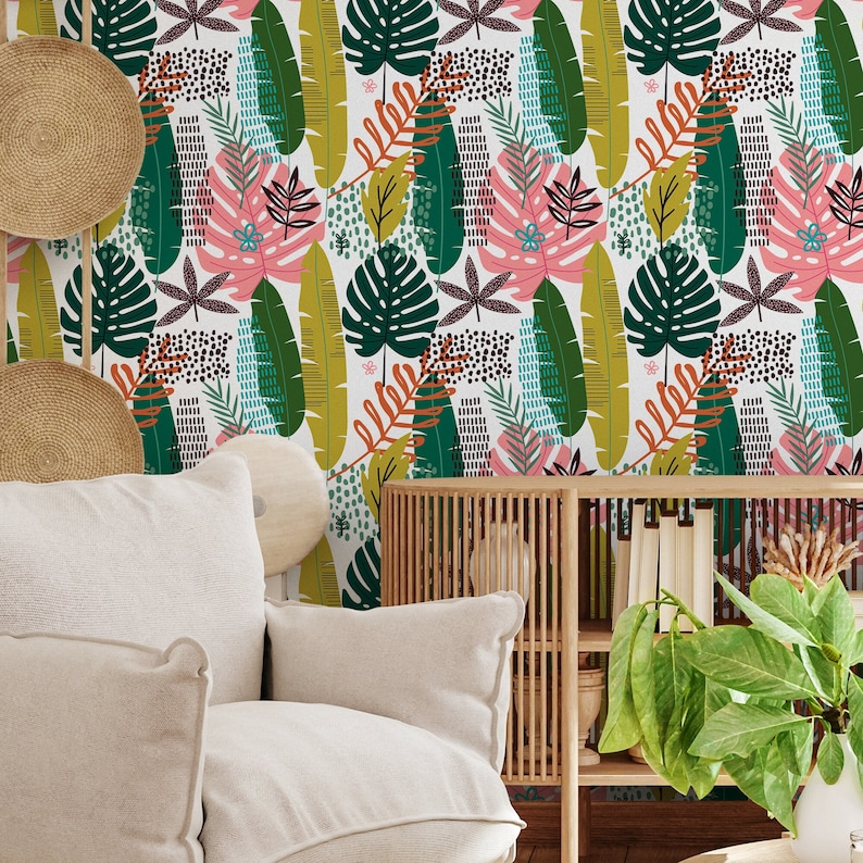May include: A white background with a repeating pattern of green, yellow, pink, and brown leaves. The leaves are stylized and abstract. The background is a white wall with a white couch and a wooden shelf with a green plant.