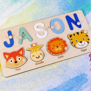 May include: A wooden puzzle board with the name "JASON" spelled out in colorful letters. The board also features animal illustrations of a fox, giraffe, lion, and tiger.