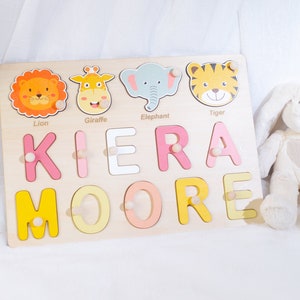 May include: Wooden name puzzle with colorful letters spelling "KIERA MOORE" and animal illustrations of a lion, giraffe, elephant, and tiger.
