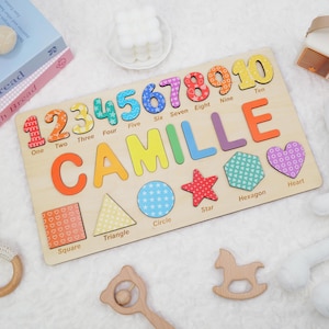 May include: A wooden puzzle with colorful numbers 1 through 10, the name Camille, and various shapes including a square, triangle, circle, star, hexagon, and heart. Each piece has a different pattern.