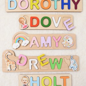 May include: Five wooden puzzle pieces with names spelled out in colorful letters. Each piece has a picture of a child and a small animal. The names are Dorothy, Dove, Amy, Drew, and Holt.