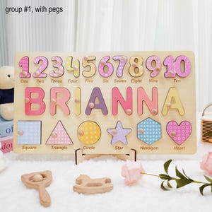 May include: Wooden puzzle with colorful numbers, letters, and shapes. The puzzle is personalized with the name "BRIANNA".