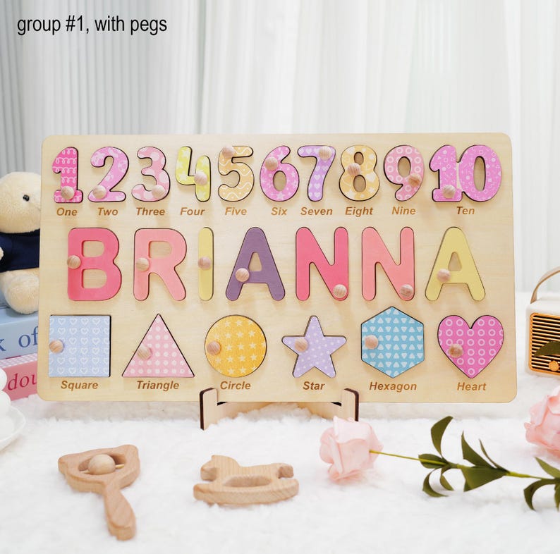 May include: Wooden puzzle with colorful numbers, letters, and shapes. The puzzle is personalized with the name "BRIANNA".